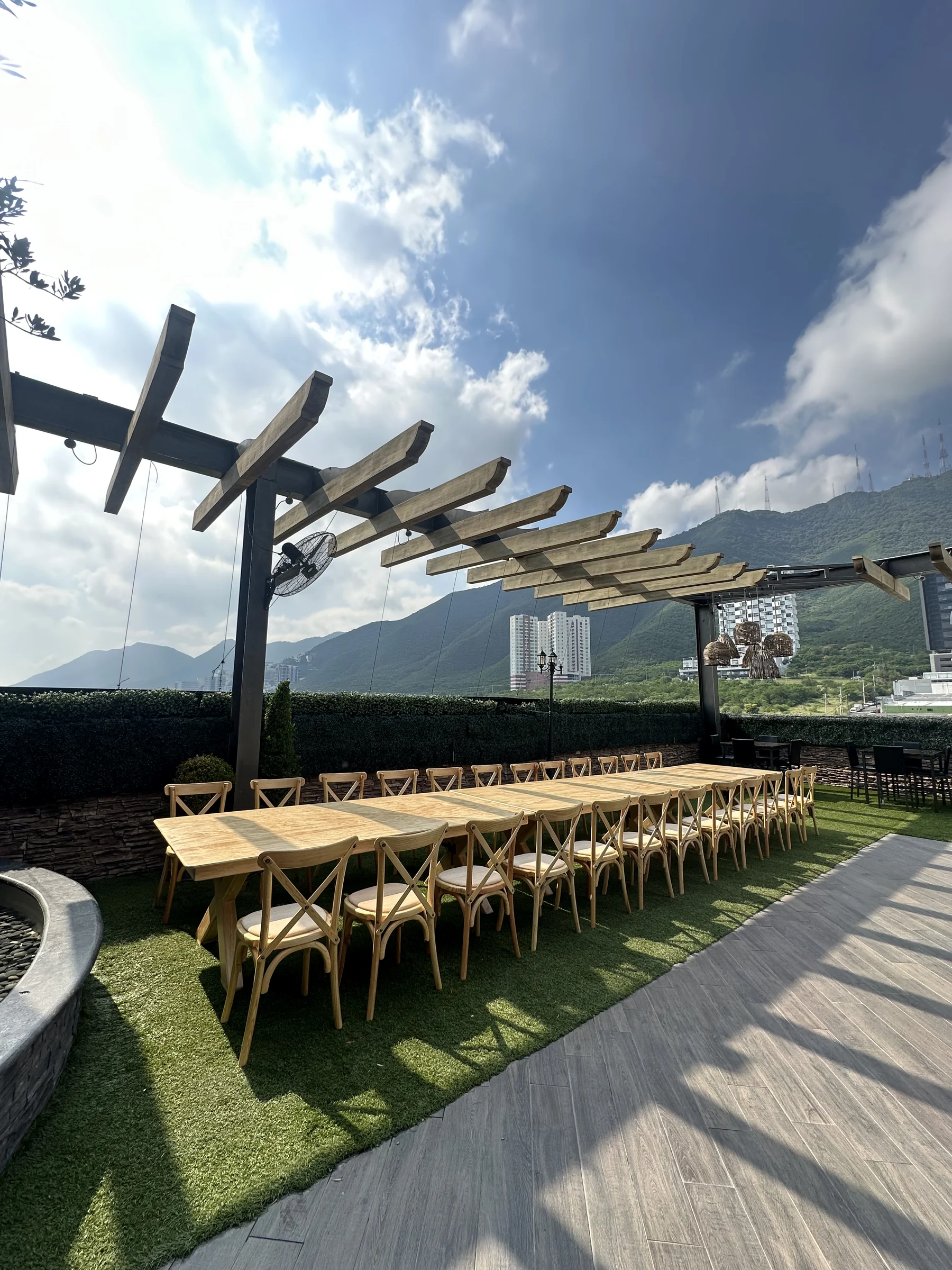 Mesa larga de madera para evento social con vista a Monterrey
